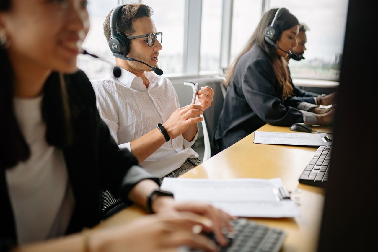 A diverse team of call center agents working together in a modern office setting.
